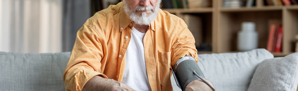 Ein Mann prüft seinen Blutdruck - er war ein Blutdruckmessgerät kaufen